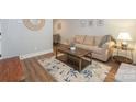 Bright living room showcasing a neutral color scheme, modern decor, and wood floors at 921 Ambassador St # 1, Charlotte, NC 28208