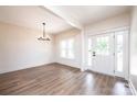 Bright living room with wood floors, modern lighting, and a white front door with side windows at 0 6Th Nw St, Hickory, NC 28601