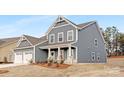 Charming home featuring blue siding, white trim, a well-manicured lawn, and a welcoming front porch at 10053 Jack Nicklaus Dr # 932, Lancaster, SC 29720