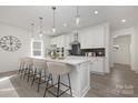 Modern kitchen featuring a large island with bar seating and stylish pendant lighting at 10053 Jack Nicklaus Dr # 932, Lancaster, SC 29720
