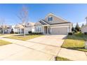 Charming one-story home with landscaped front yard, long driveway, and attached two car garage at 106 Chase Water Dr, Mooresville, NC 28117
