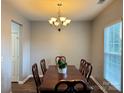 Formal dining room featuring a wooden table, chairs, and chandelier lighting at 14809 Castletown House Dr, Charlotte, NC 28273