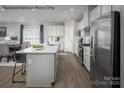 Bright kitchen featuring an island with a sink, stainless steel appliances, and a breakfast nook at 1809 Ab Moore Jr Dr # 3238, Indian Trail, NC 28079