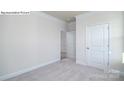 Cozy bedroom showcasing neutral carpet, white trim, and a spacious closet at 2016 Skyhawk Dr, Lake Wylie, SC 29745