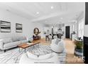 Open-concept living room with a large rug and a view of the dining area and kitchen at 2021 Mandarin Blvd, Charlotte, NC 28205