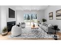 Bright living room with a modern fireplace and sliding glass doors that lead to the backyard at 2021 Mandarin Blvd, Charlotte, NC 28205