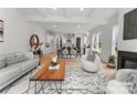A large open-concept living room with a fireplace and windows, with modern decor and beautiful hardwood floors at 2021 Mandarin Blvd, Charlotte, NC 28205