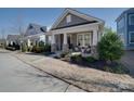 Attractive home with a covered porch, stone pillar accents, and well-maintained landscaping, creating a warm and inviting atmosphere at 205 Mac Aly, Cramerton, NC 28032