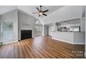 Bright living room featuring fireplace, vaulted ceiling, and breakfast bar at 2500 Cranbrook Ln # 5, Charlotte, NC 28207