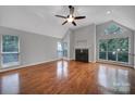 Bright living room showcasing wood floors, a fireplace, vaulted ceilings, and large windows at 2500 Cranbrook Ln # 5, Charlotte, NC 28207