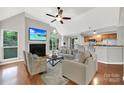 Open-concept living room features a fireplace, large windows, and seamless transition to the modern kitchen at 2500 Cranbrook Ln # 5, Charlotte, NC 28207