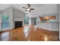 Spacious living room with vaulted ceiling, fireplace, hardwood floors, and natural light from large windows at 2500 Cranbrook Ln # 5, Charlotte, NC 28207
