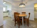 Cozy dining area with wood table, chairs, and view into the kitchen, great for gatherings at 2900 Heathstead Pl # A, Charlotte, NC 28210