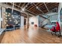 Spacious living area featuring an open floor plan, hardwood floors, exposed beams, and modern lighting at 310 Arlington Ave # Multiple, Charlotte, NC 28203