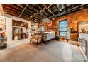 Comfortable bedroom featuring exposed brick, wood ceilings and large windows for great natural light at 310 Arlington Ave # Multiple, Charlotte, NC 28203