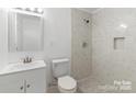 Bathroom with tile shower, a modern vanity, updated fixtures, and neutral finishes at 332 Mountain View St, Gastonia, NC 28052