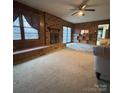 Spacious living room featuring a brick fireplace, wood paneling, and natural light at 3367 Marshall Wolfe Rd, Kings Mountain, NC 28086
