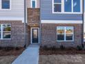 A welcoming brick townhome entrance with a covered porch and clear address number displayed above the door at 3924 Craig Ave, Charlotte, NC 28211