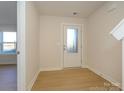 Bright foyer featuring tile floors, a glass paneled front door, and neutral paint, perfect for a fresh entrance at 3924 Craig Ave, Charlotte, NC 28211