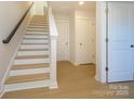 Inviting staircase showcasing wood stairs, a white banister, and natural light for a bright, modern feel at 3924 Craig Ave, Charlotte, NC 28211