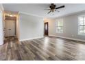 Inviting living room featuring stylish wood floors, neutral paint, and plenty of natural light from bright windows at 406 Llewellyn St, Belmont, NC 28012