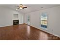 Bright living room with a fireplace, hardwood floors, and natural light at 414 Fox Fire Run, Gastonia, NC 28052