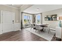 Bright dining room with hardwood floors, a modern light fixture, and large windows at 419 Balboa St, Matthews, NC 28104