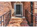 Inviting front entrance with brick steps, black railings and decorative door at 4522 Long Cove Dr, Denver, NC 28037