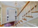 Bright foyer with hardwood floors, a staircase, and a decorative front door with stained glass at 4605 Curraghmore Rd, Charlotte, NC 28210