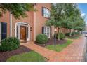 Inviting red brick home with a manicured lawn, a brick walkway, and a decorative front door at 4605 Curraghmore Rd, Charlotte, NC 28210