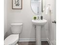 Charming half bathroom featuring a pedestal sink, neutral paint, and decorative mirror at 5050 Beargrass Dr, Dallas, NC 28034