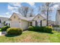 Charming single-Gathering home featuring a well-manicured lawn and attached one car garage at 5120 Silabert Ave, Charlotte, NC 28205