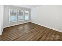 Well-lit bedroom with hardwood floors, neutral walls, and large windows for natural light at 665 Cypress Glen Ln, Clover, SC 29710