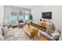 Bright living room featuring large windows, stylish furniture, and hardwood floors at 665 Cypress Glen Ln, Clover, SC 29710