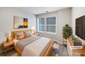 Cozy bedroom with wood frame bed, soft textures, and ample natural light from large windows at 665 Cypress Glen Ln, Clover, SC 29710