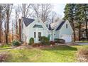 Charming home with well-kept lawn and professional landscaping, surrounded by mature trees at 7007 Chapparall Ln, Charlotte, NC 28215