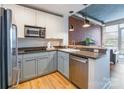 Well-lit kitchen featuring stainless steel appliances, modern cabinetry and a brick accent wall at 710 W Trade St # 314, Charlotte, NC 28202