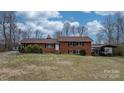 Well-maintained brick home with a cozy carport and manicured bushes at 9257 Mull Rd, Vale, NC 28168