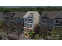 Aerial view highlighting the charming townhome's exterior and surrounding landscaped grounds at 9330 Ainslie Downs St, Charlotte, NC 28273