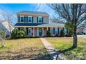 Traditional two-story home with a well-maintained lawn, mature trees, and classic curb appeal at 102 Brewster Ct, Mooresville, NC 28115