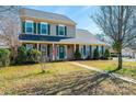 Attractive home featuring green shutters, a tidy lawn, and a charming walkway leading to the entrance at 102 Brewster Ct, Mooresville, NC 28115