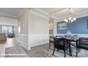 Elegant dining space with decorative molding, wood floors, leading to kitchen and living room at 149 Saidin Ln, Troutman, NC 28166
