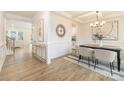 A dining area featuring elegant trim work, a stylish chandelier, and a modern table setting at 149 Saidin Ln, Troutman, NC 28166