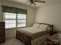 Cozy bedroom with neutral carpet, ceiling fan, and ample natural light at 167 Patterson Rd, Kings Mountain, NC 28086