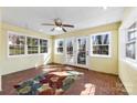 Bright sun room with brick accent, lots of windows, and french doors to the outdoors at 1701 Montclair Ave, Gastonia, NC 28054