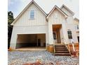 Eye-catching home featuring an attached two-car garage, covered entryway, and wood-stained entry stairs at 2530 Elkwood Cir, Charlotte, NC 28205