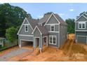 New construction home featuring gray siding, white trim, and an attached garage at 2530 Elkwood Cir, Charlotte, NC 28205