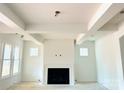 Open living room featuring a fireplace with black trim, and large windows for natural light at 2530 Elkwood Cir, Charlotte, NC 28205