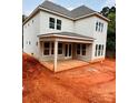Newly constructed home featuring a covered porch and a walk-out basement at 2530 Elkwood Cir, Charlotte, NC 28205