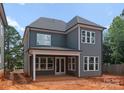 Rear exterior of new construction home with covered patio and lots of windows at 2530 Elkwood Cir, Charlotte, NC 28205